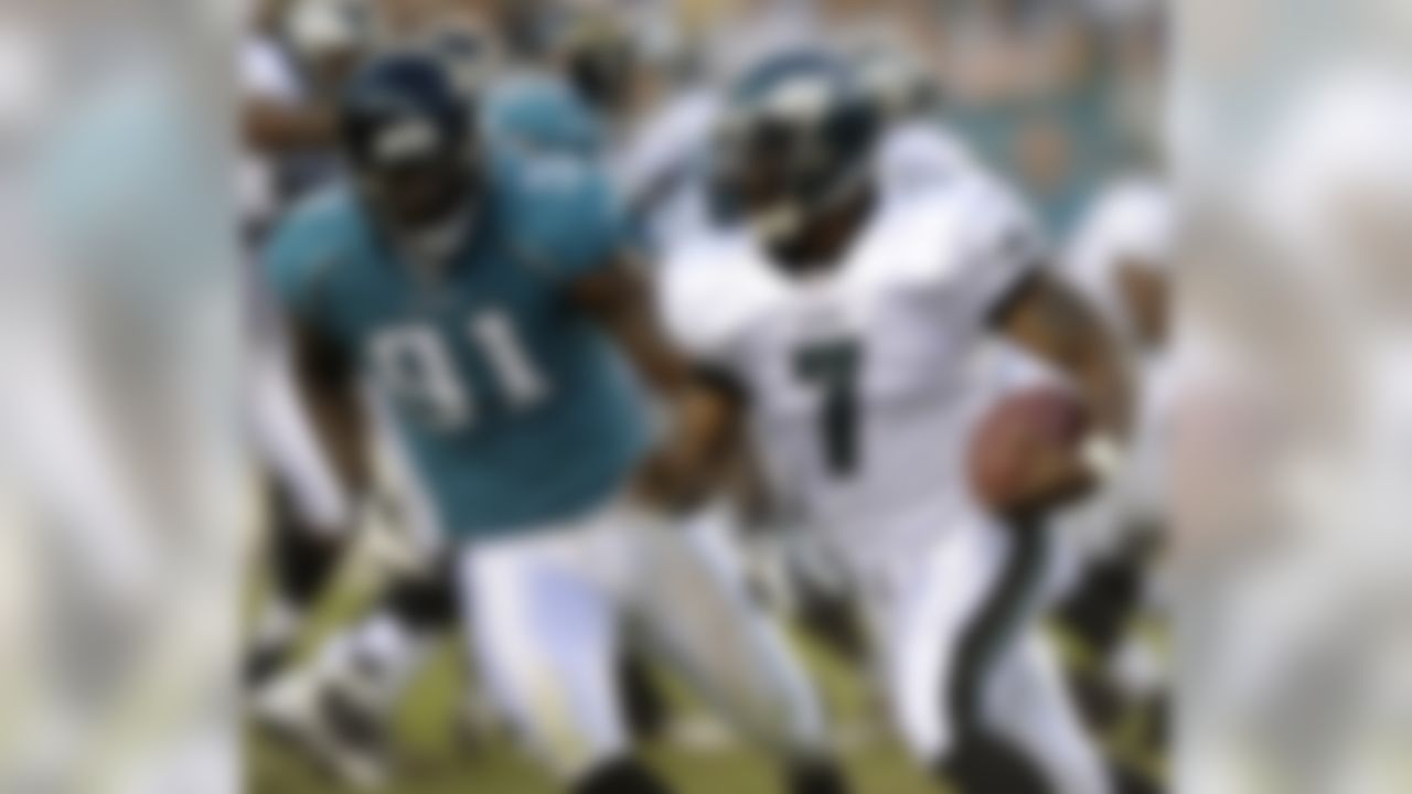 Philadelphia Eagles quarterback Michael Vick, right, tires to scramble past Jacksonville Jaguars defensive end Derrick Harvey during the first quarter of a preseason NFL football game Thursday, Aug. 27, 2009, in Philadelphia. (AP Photo/Michael Perez)