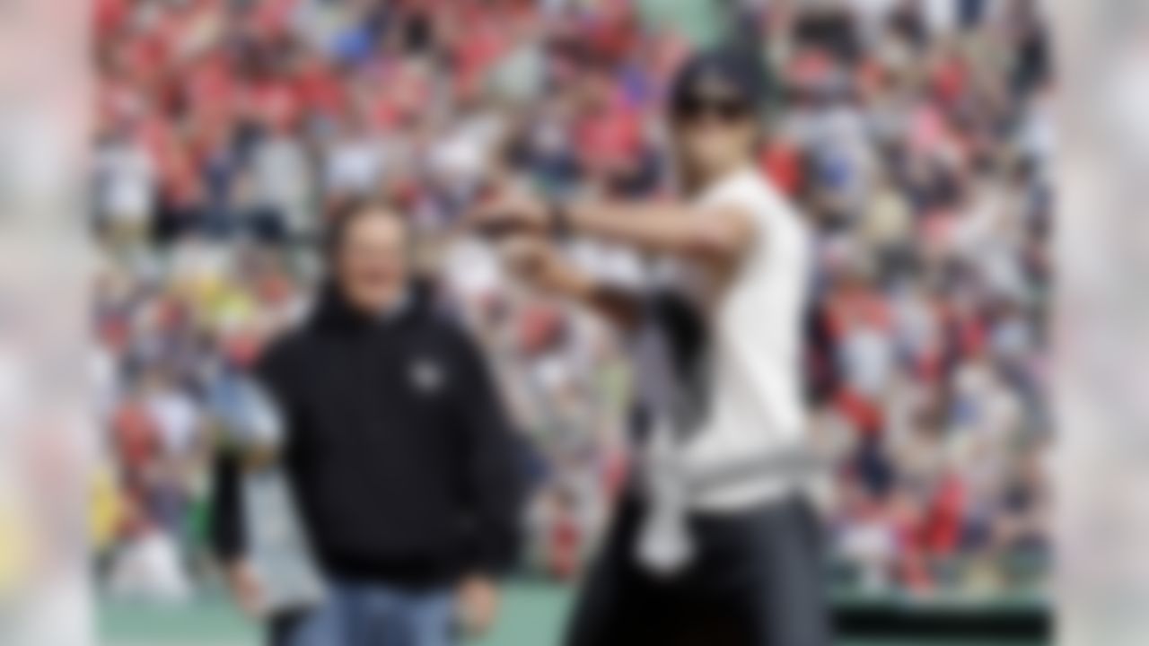 New England Patriots quarterback Tom Brady throws the ceremonial first pitch as Patriots head coach Bill Belichick watches prior to the home opener baseball game between the Boston Red Sox and the Washington Nationals at Fenway Park in Boston, Monday, April 13, 2015. (AP Photo/Elise Amendola)