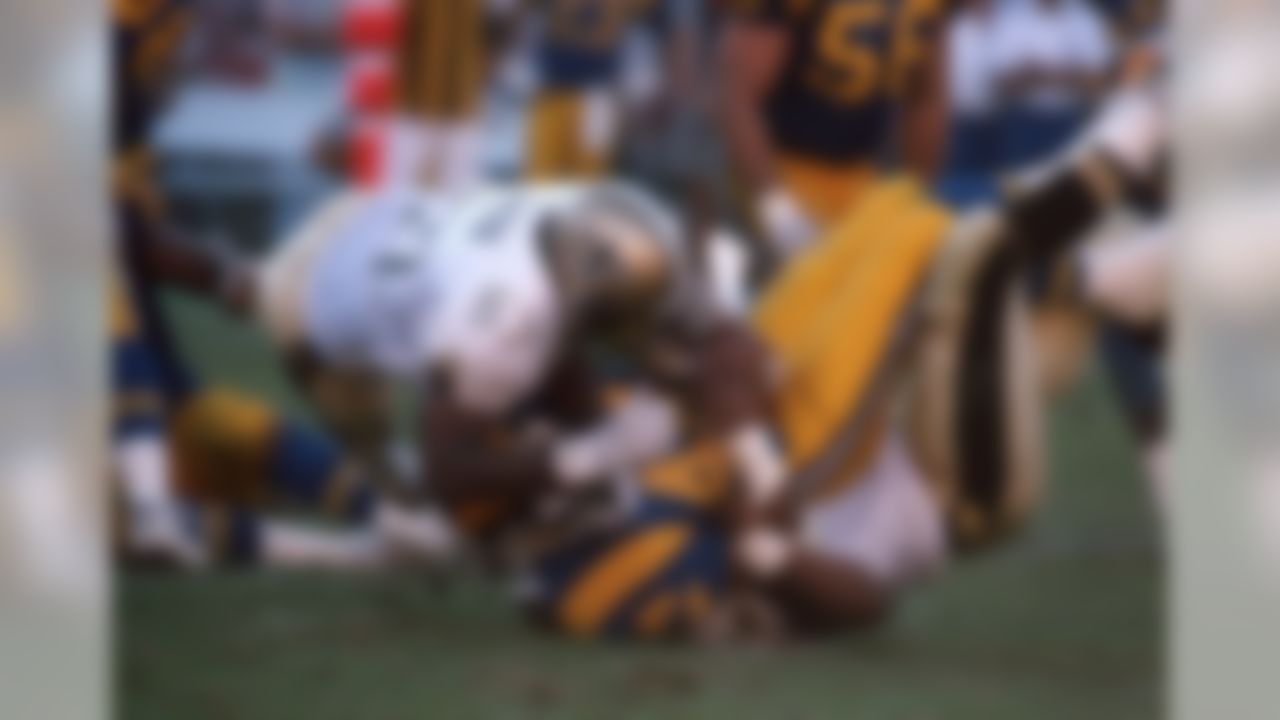 New Orleans Saints linebacker Rickey Jackson (57) tackles Rams running back Gaston Green (44) in a 24 to 20 New Orleans Saints win over the Los Angeles Rams on December 9, 1990 at Anaheim Stadium in Anaheim, CA. (National Football League)