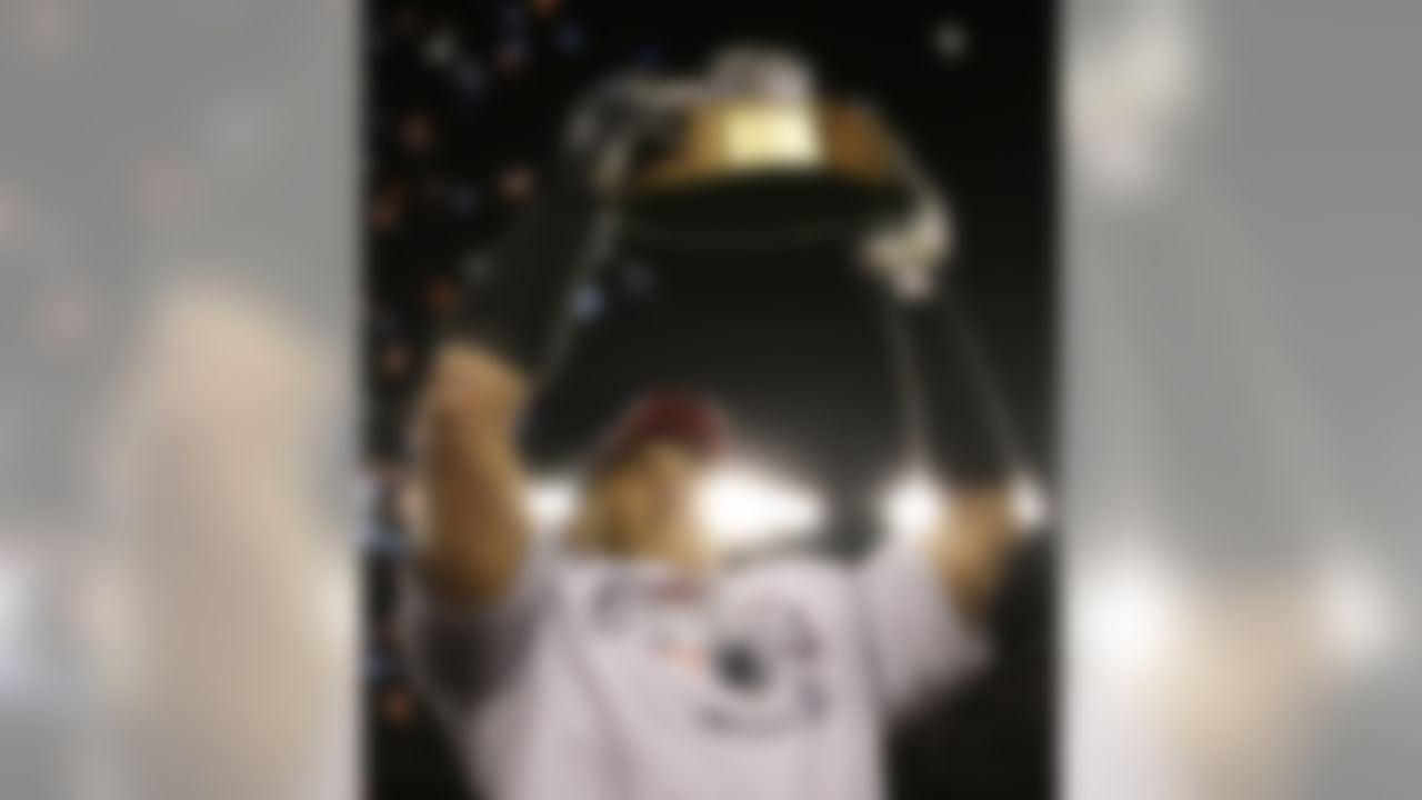 New England Patriots' Junior Seau holds the Lamar Hunt trophy after the Patriots beat the San Diego Chargers 21-12 to win the AFC Championship football game in Foxborough, Mass., Sunday, Jan. 20, 2008, and advance to the Super Bowl. (AP Photo/Stephan Savoia)