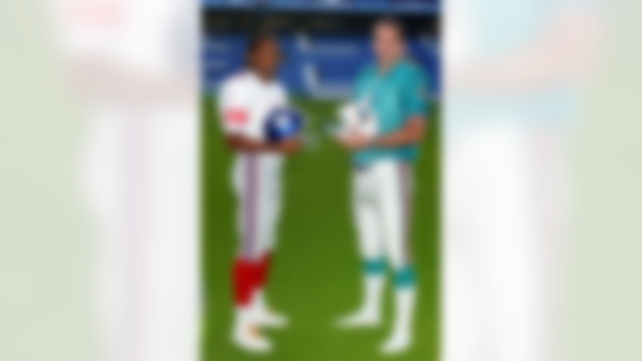 Honorary New York Giants captain, Chelsea soccer star Didier Drogba, left, and Miami Dolphins honorary captain, former England rugby captain, Martin Johnson, pose for photographers in full NFL kit at the Stamford Bridge Stadium, London, Tuesday Oct. 23, 2007. The Miami Dolphins are due to play against the New York Giants at Wembley Stadium, London, Sunday Oct. 28, 2007. (AP Photo/Tom Hevezi)