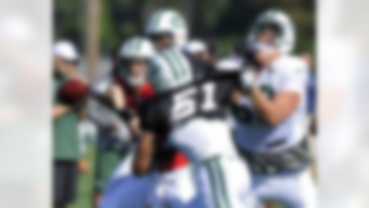 New York Jets offensive tackle Paul Cornick, right, attempts to protect quarterback Greg McElroy, left, from being sacked by linebacker Aaron Maybin (51) at their NFL football training camp Monday, July 30, 2012, in Cortland, N.Y. (AP Photo/Bill Kostroun)