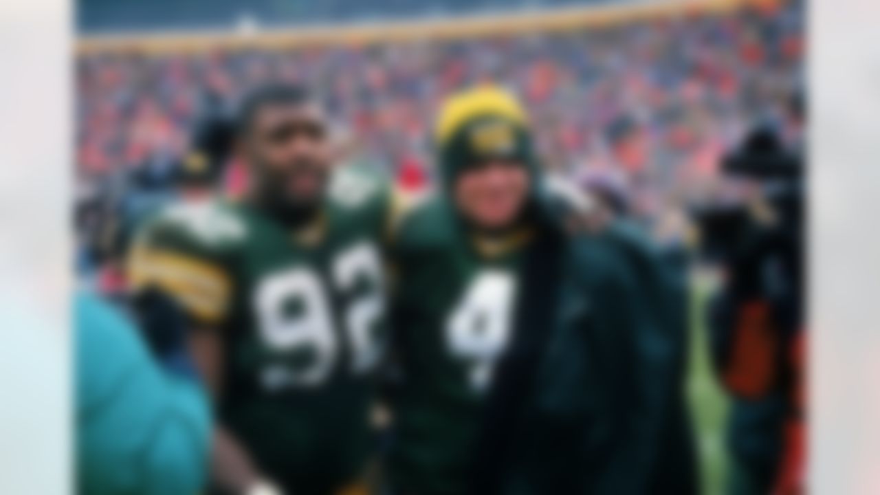 Green Bay Packers defensive end Reggie White (92) and quarterback Brett Favre (4) celebrate after an NFL football game against the Chicago Bears at Lambeau Field on November 12, 1995 in Green Bay, Wisconsin. (AP Photo/David Stluka)