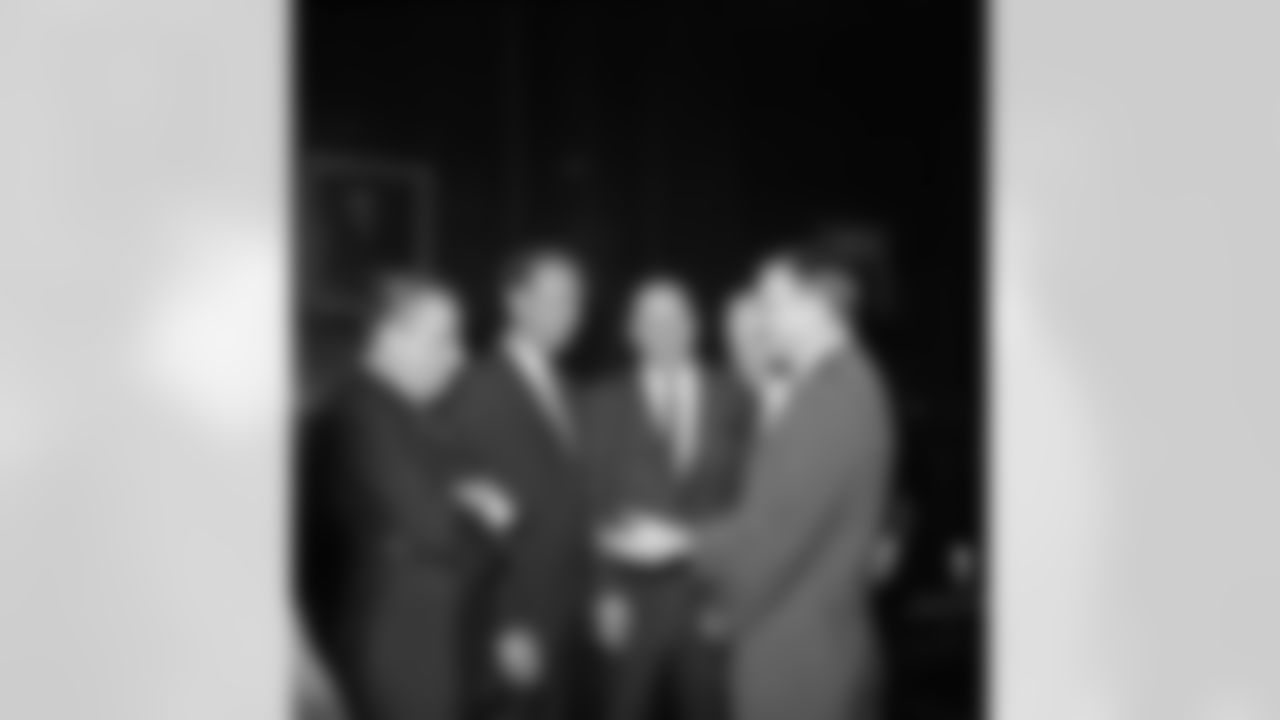 Commissioners and team representatives of the American and National football leagues talk before the start of a House Judiciary Subcommittee hearing in Washington, D.C. on Oct. 11, 1966. From left to right are, Art Modell, president of the Cleveland Browns; Peter Rozelle, National Football League commissioner; Tex Schramm, Dallas Cowboys president; Milt Woodard, American Football League commissioner; and Lamar Hunt, president of the Kansas City Chiefs. The hearing is on the Senate-passed bill that would exempt merger of the leagues from anti-trust laws. (Associated Press)