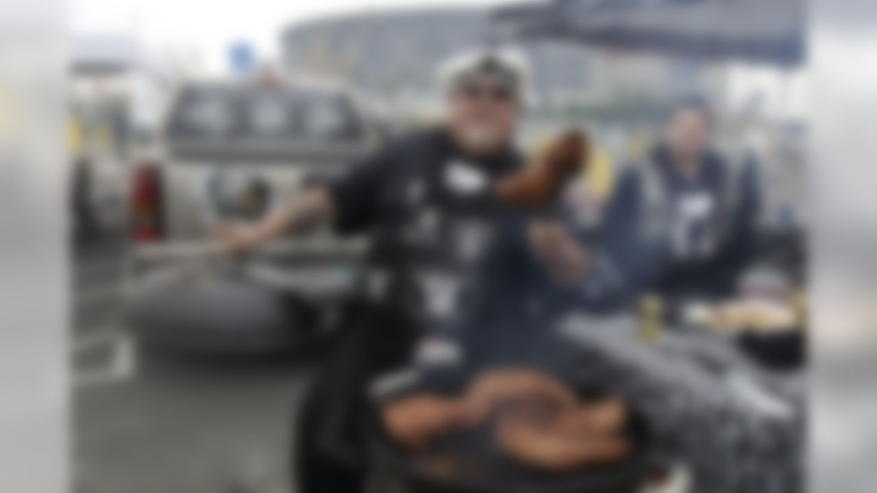 Football fans tailgate before an NFL football game between the Oakland Raiders and the Detroit Lions in Oakland, Calif., Sunday, Dec. 18, 2011. (AP Photo/Paul Sakuma)