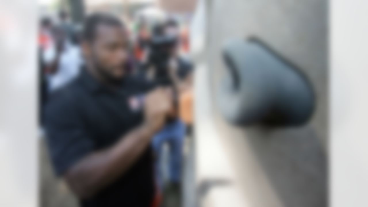 Braylon Edwards works to ensure the climbing wall pieces are on just right. (Photo by Alan Marler/CIA Stock Photography, Inc.)