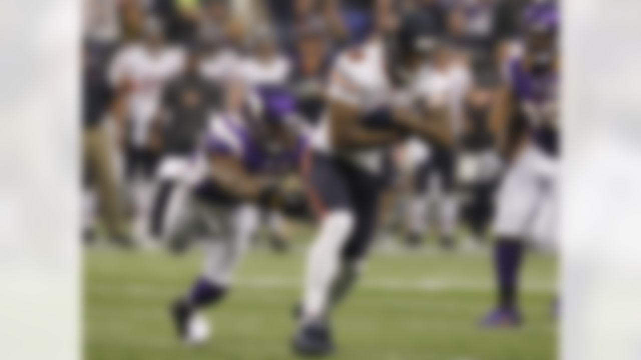 Chicago Bears wide receiver Brandon Marshall (15) tries to break a tackle by Minnesota Vikings linebacker Erin Henderson, left, after making a reception during the first half of an NFL football game Sunday, Dec. 9, 2012, in Minneapolis. (AP Photo/Genevieve Ross)
