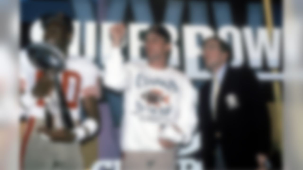 San Francisco 49er's quarterback Joe Montana (center) and wide reciever Jerry Rice (left) stand with the Super Bowl XXIV trophy on January 28, 1990. San Francisco defeated the Denver Broncos 55 to 10. (Al Messerschmidt/NFL)