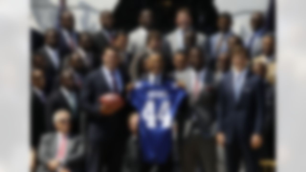 President Barack Obama poses with New York football Giants, including captains, from left, Zak DeOssie, Justin Tuck, and Eli Manning during a ceremony on the South Lawn of the White House in Washington, Friday, June 8, 2012, to honor the Super Bowl XLVI Champions. (AP Photo/Charles Dharapak)
