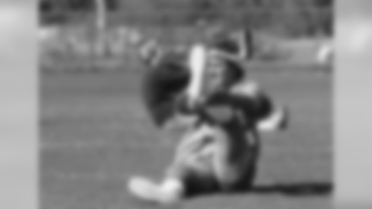 Miami Dolphins quarterback Dan Marino stretches out his leg at the start of practice as the Dolphins prepare to meet Pittsburgh, Monday, Dec. 31, 1984, Miami, Fla. (AP Photo/Raul De Molina)