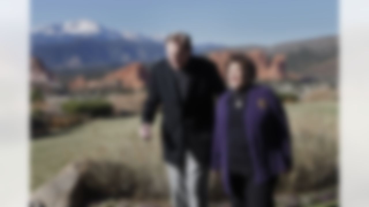 In this Nov. 14, 2011 photo, Hall of Fame football player Forrest Gregg and his wife Barbara are pictured with Pikes Peak and the Garden of the Gods in the background after an interview where he talked about his battle with Parkinson's disease, in Colorado Springs, Colo. (AP Photo/Ed Andrieski)