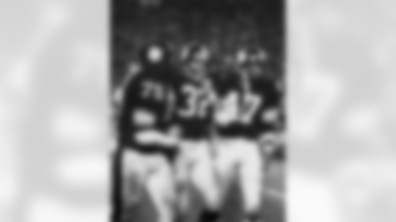 Pittsburgh Steelers Hall of Fame defensive tackle Joe Greene (75), Hall of Fame running back Franco Harris (32), and Hall of Fame cornerback Mel Blount (47) walk off field after Harris scored a touchdown in a 35-31 win over the Dallas Cowboys in Super Bowl XIII. (National Football League)
