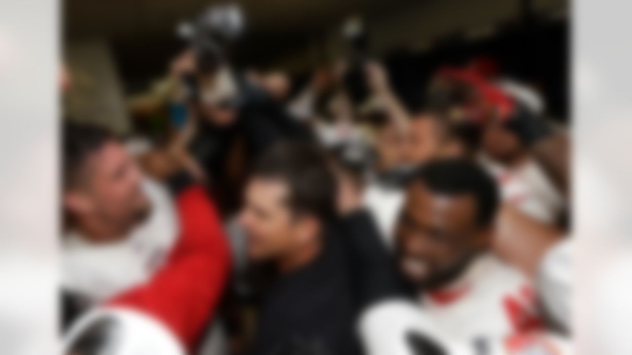 The San Francisco 49ers celebrate with head coach Jim Harbaugh, center, after the NFL football NFC Championship game against the Atlanta Falcons Sunday, Jan. 20, 2013, in Atlanta. The 49ers won 28-24 to advance to Super Bowl XLVII. (AP Photo/Dave Martin)