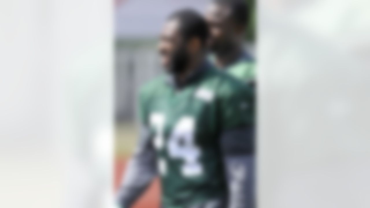 New York Jets cornerback Darrelle Revis smiles as he leaves the practice field on opening day of their NFL football training camp Friday, July 27, 2012, in Cortland, N.Y. (AP Photo/Bill Kostroun)
