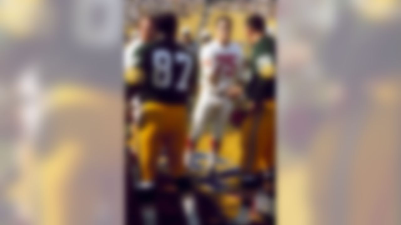 Green Bay Packers Hall of Fame defensive end Willie Davis (87) and tackle Ron Kostelnik (76) greet Kansas City Chiefs defensive end Jerry Mays (75) before Super Bowl I, on January 15, 1967. (National Football League)