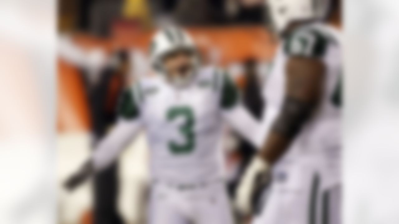 New York Jets kicker Jay Feely (3) celebrates with New York Jets tackle Damien Woody (67) after Feely kicked a field goal against the Cincinnati Bengals in the second half of an NFL wild-card playoff football game, Saturday, Jan. 9, 2010, in Cincinnati. New York won 24-14. (AP Photo/Ed Reinke)