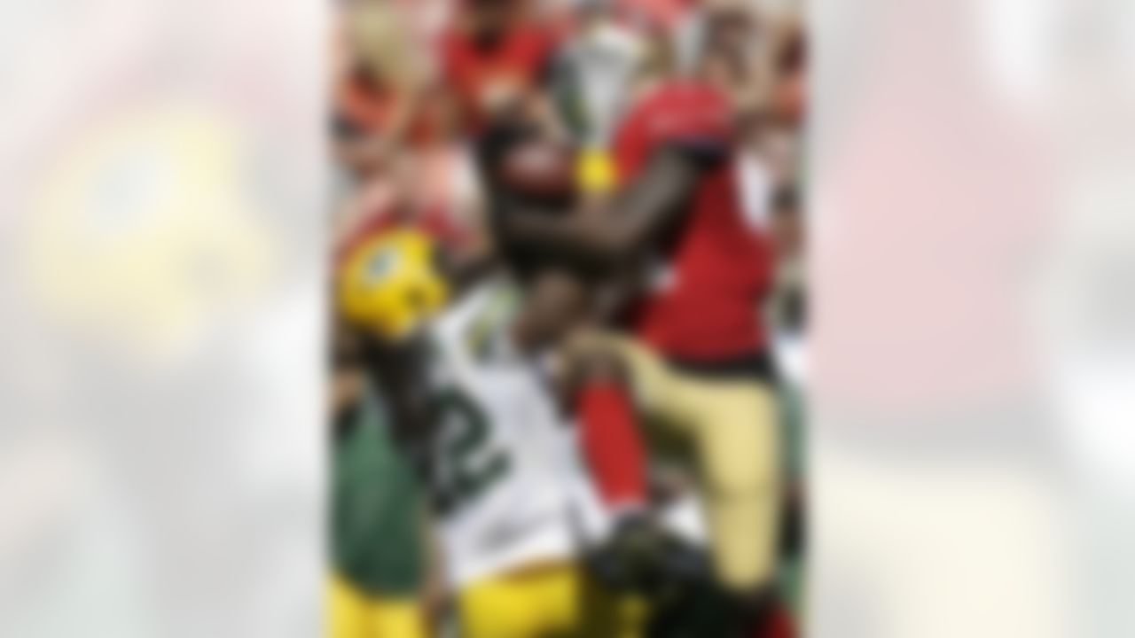 San Francisco 49ers wide receiver Anquan Boldin catches a pass over Green Bay Packers defensive back Jerron McMillian (22) during the second quarter of an NFL football game in San Francisco, Sunday, Sept. 8, 2013. (AP Photo/Marcio Jose Sanchez)