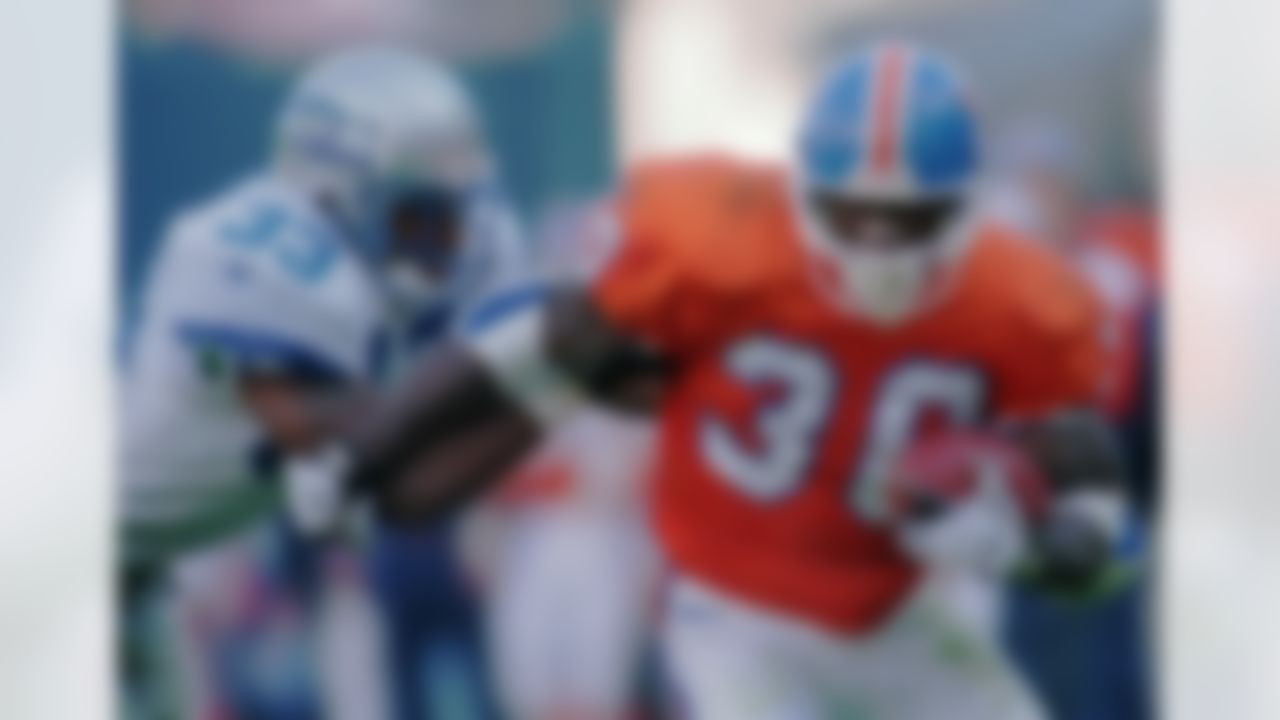 Denver Broncos running back Terrell Davis, right, is pulled down from the side by Seattle Seahawks Darryl Williams in the second quarter of the Broncos' 34-7 victory in Denver's Mile High Stadium on Sunday, Dec. 1, 1996. (AP Photo/Bryan Kelsen)