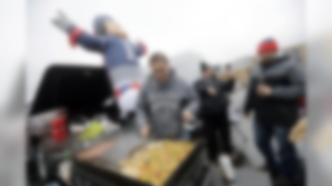 Pete Roy tends the grill while tailgating with friends in the parking lot of Gillette Stadium before an NFL divisional playoff football game between the New England Patriots and the Kansas City Chiefs, Saturday, Jan. 16, 2016, in Foxborough, Mass. (AP Photo/Elise Amendola)