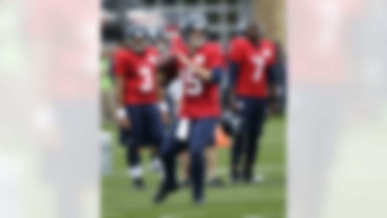 Seattle Seahawks quarterback Matt Flynn (15) looks to pass as rookie quarterback Russell Wilson (3) and last-year's starter Tavaris Jackson (7), look on during practice drills, Monday, July 30, 2012, at NFL football training camp in Renton, Wash. (AP Photo/Ted S. Warren)