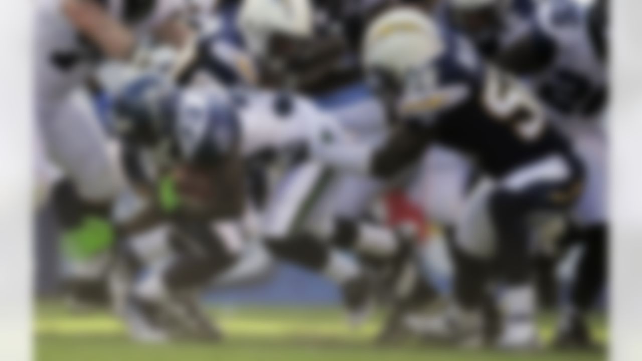 Seattle Seahawks running back Leon Washington (33), left, is held up by San Diego Chargers linebacker Donald Butler during the first half of their preseason NFL football game at Qualcomm Stadium, Thursday, Aug. 11, 2011, in San Diego. (AP Photo/Mark J. Terrill)