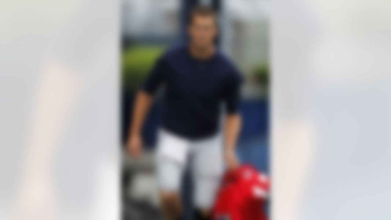 New England Patriots quarterback Tom Brady (12) steps on to the field before an NFL football training camp in Foxborough, Mass., Sunday, July 29, 2012. (AP Photo/Steven Senne)