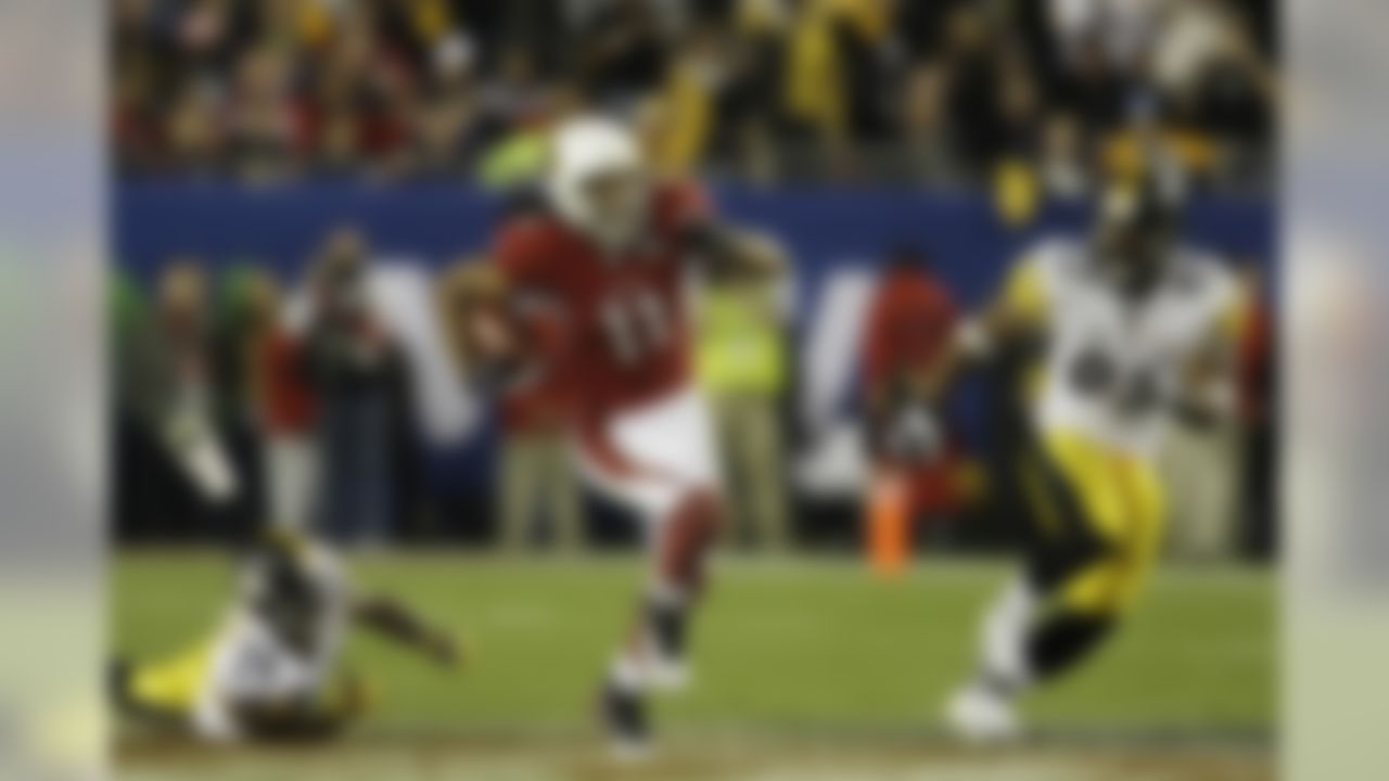 Arizona Cardinals wide receiver Larry Fitzgerald passes Pittsburgh Steelers defenders Adrian Wilson (24) and Bertrand Berry (92) on his 64-yard touchdown reception in the fourth quarter of the NFL Super Bowl XLIII football game, Sunday, Feb. 1, 2009, in Tampa, Fla. (AP Photo/Ross D. Franklin)