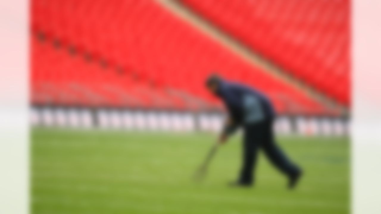 LONDON - OCTOBER 27: A groundskeeper replaces the divots in the field after practice a day before the game between the Miami Dolphins and the New York Giants on October 27, 2007 at Wembley Stadium in London, England. (Photo by Al Bello/Getty Images)