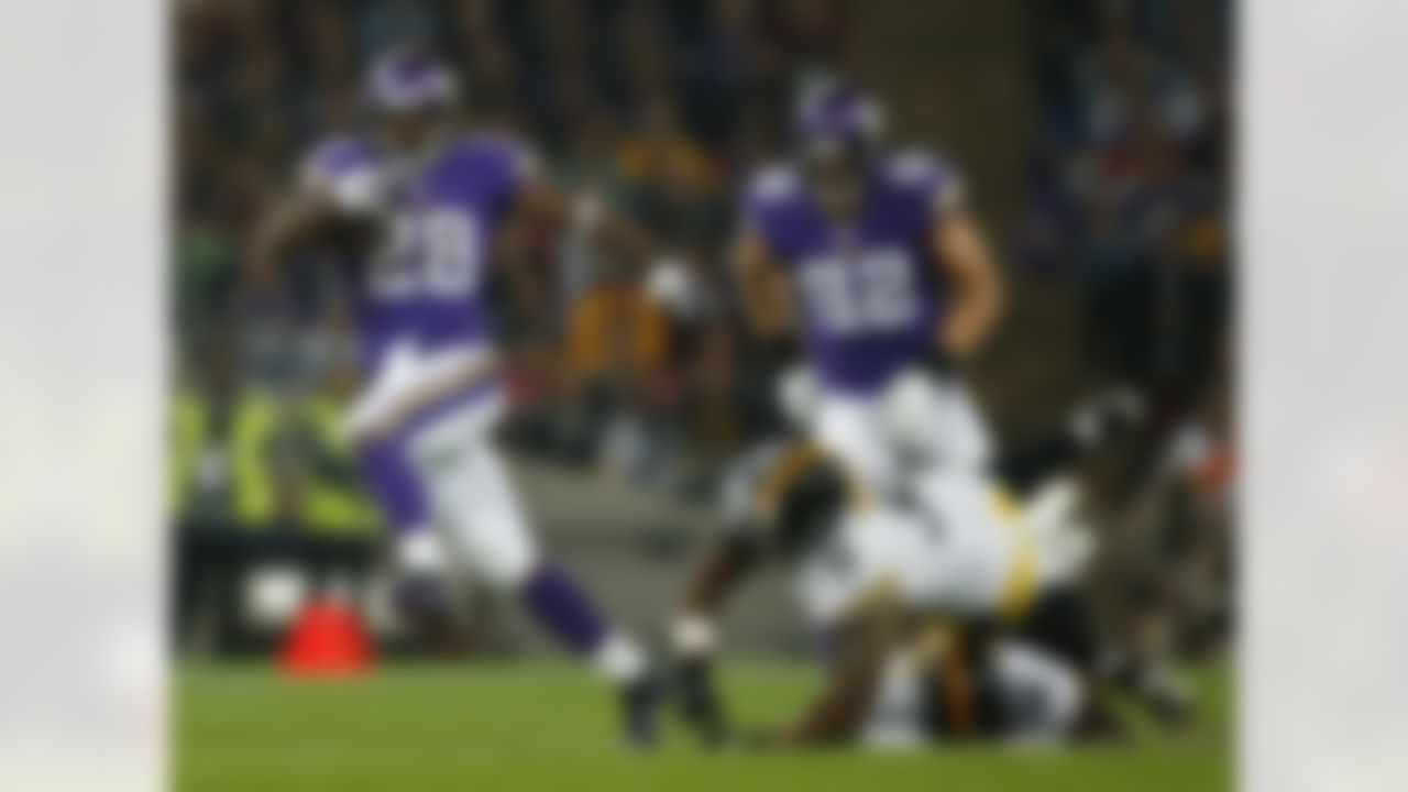 Minnesota Vikings running back Adrian Peterson (28) evades a tackle by Pittsburgh Steelers linebacker LaMarr Woodley (56) to score on a 70-yard touchdown run during the first half of their NFL football game at Wembley Stadium, London, Sunday,Sept. 29, 2013. (AP Photo/Matt Dunham)