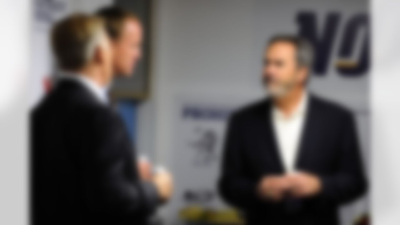 May 11, 2012; San Diego, CA, USA; San Diego Chargers former player Dan Fouts (right) talks with Denver Broncos executive vice president of football operations John Elway (left) and quarterback Peyton Manning (center) prior to a celebration of life service to remember Junior Seau at Qualcomm Stadium. Mandatory Credit: Christopher Hanewinckel-US PRESSWIRE