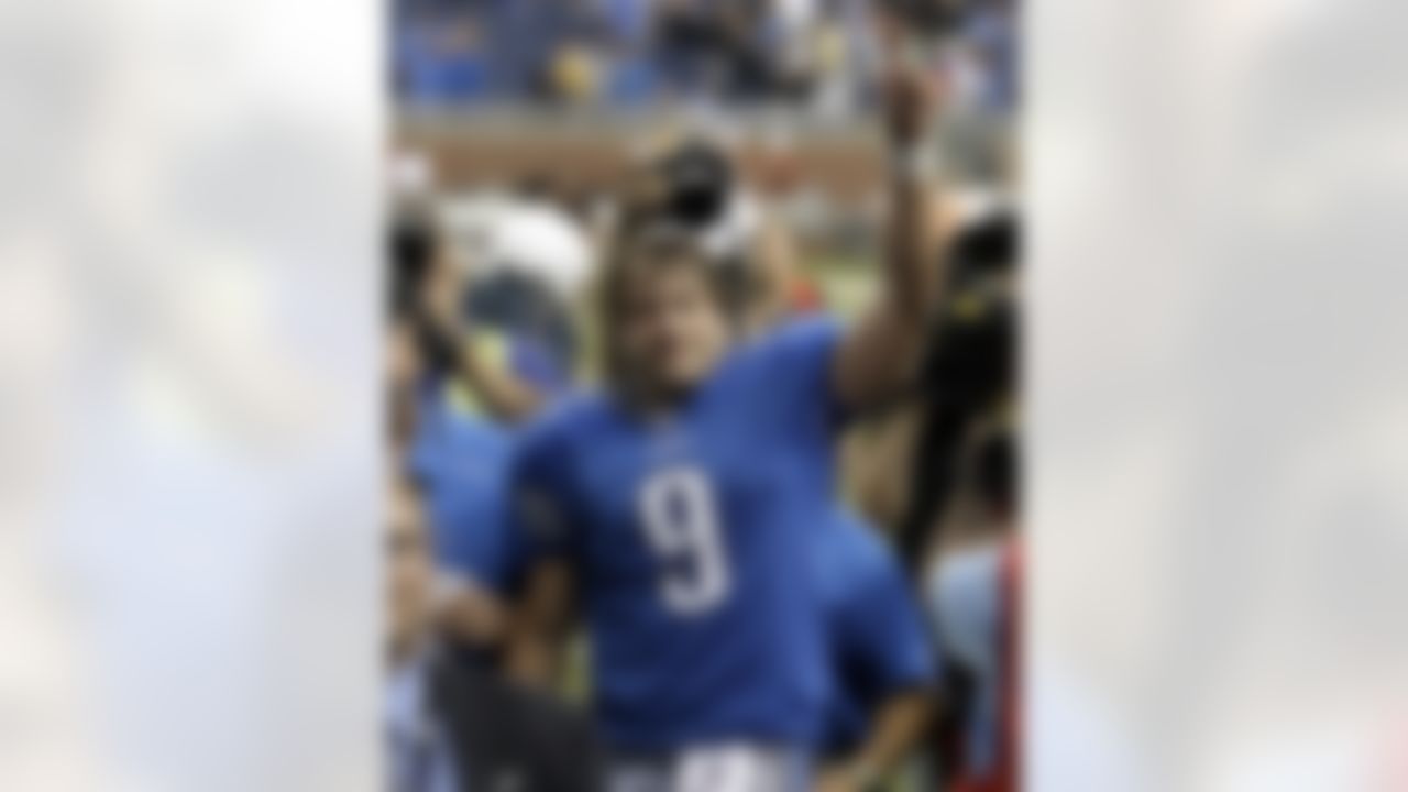 FILE - In this Sept. 27, 2009, file photo, Detroit Lions quarterback Matthew Stafford celebrates with fans after the Lions beat the Washington Redskins 19-14 in an NFL football game in Detroit. The Lions ended their 19-game losing streak with the victory. (AP Photo/Paul Sancya, File)