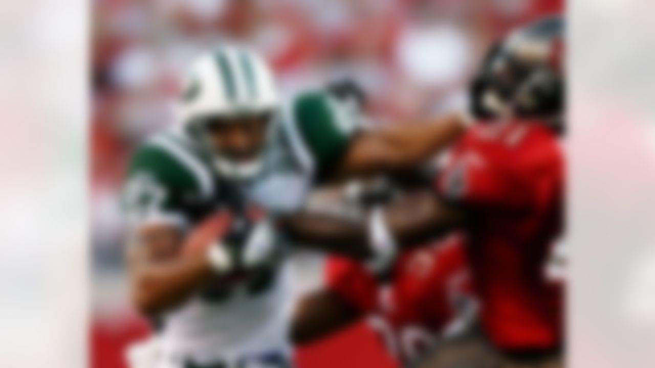 TAMPA, FL - AUGUST 11: Wide receiver Laveranues Coles #87 of the New York Jets breaks a tackle attempt by Juran Bolden #21 of the Tampa Bay Buccaneers at Raymond James Stadium on August 11, 2006 in Tampa, Florida. Photo by Doug Benc/Getty Images.
