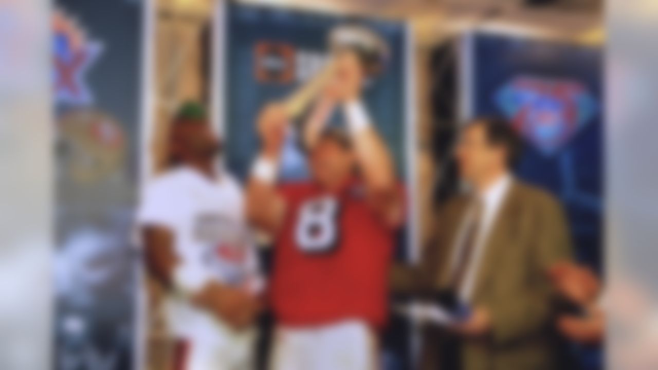 FILE - In this Jan. 29, 1995, file photo, San Francisco quarterback Steve Young, center, and receiver Jerry Rice, left, celebrate with the Lombardi Trophy after their 49-26 victory over the San Diego Chargers in Super Bowl XXIX at Joe Robbie Stadium in Miami, Fla. At right is sportscaster Brent Musberger. The 49ers are looking to win their sixth title when they take on the Baltimore Ravens in NFL football's Super Bowl XLVII on Sunday in New Orleans. (AP Photo/Eric Risberg, File)
