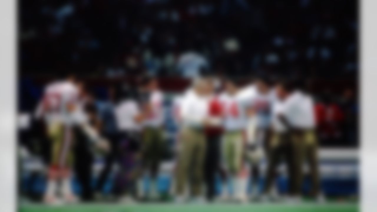 San Francisco 49ers head coach George Seifert shakes hands with linebacker Matt Millen (55) on the sideline during a Super Bowl XXIV NFL game against the Denver Broncos in New Orleans, on January 28, 1990. The 49ers defeated the Broncos 55-10. (AP Photo/Eric Lars Bakke)