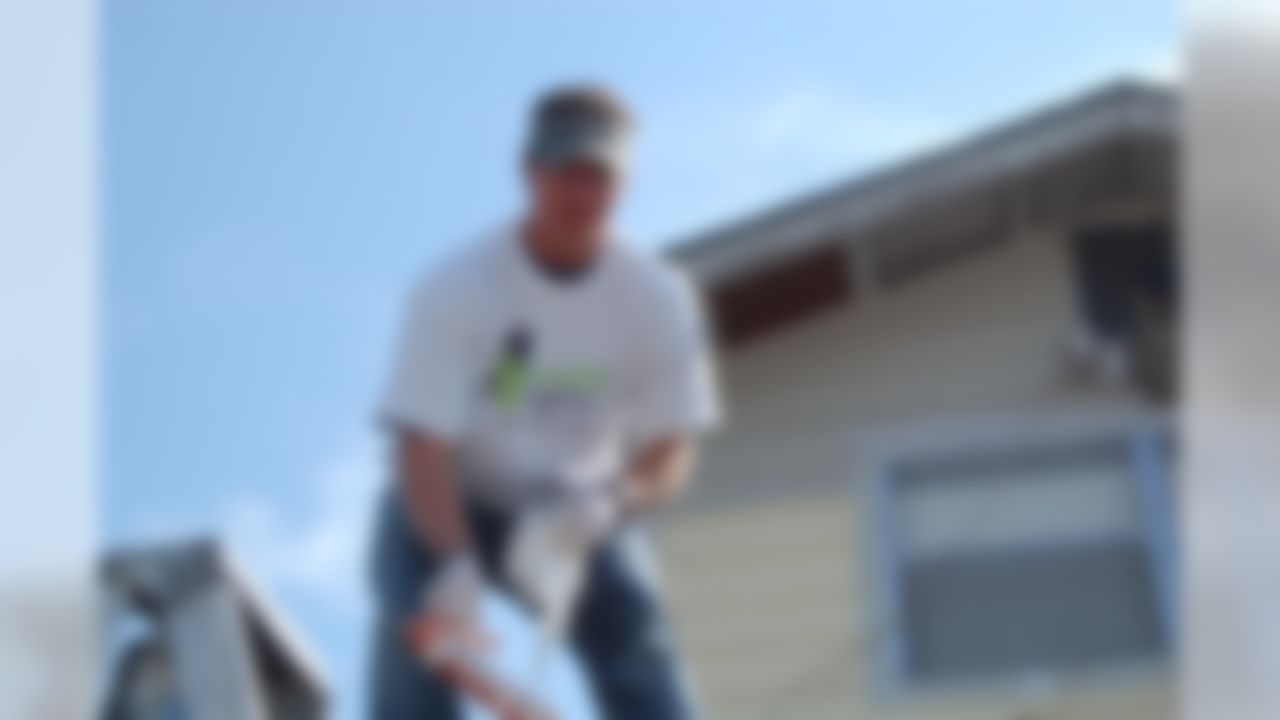 Drew Brees of the New Orleans Saints helps to rebuild a home ravaged by Hurricane Katrina in New Orleans, Louisiana on June 10, 2008.