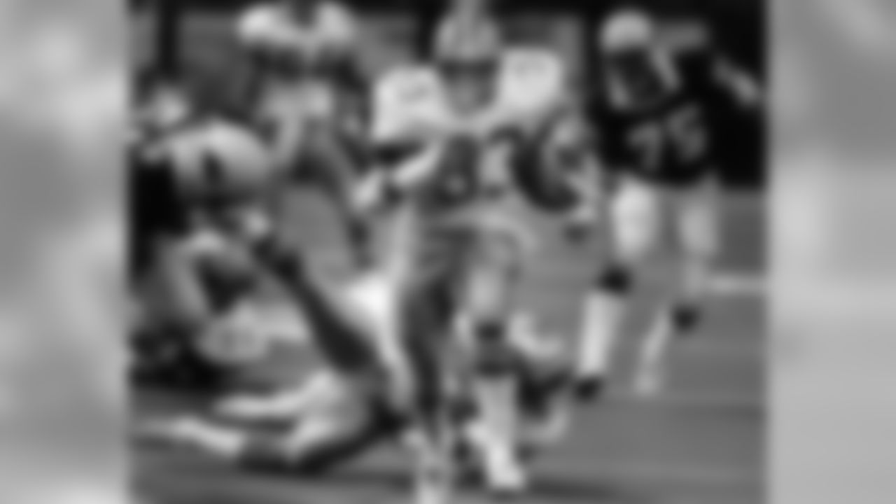Dallas Cowboys Hall of Fame running back Tony Dorsett (33) tramples everyone on the field as he runs for 102 yards with a 5 and 55 yard touchdowns and passes Larry Csonka to become the 8th all-time rusher with 8,153 yards during a win over the St. Louis Cardinals 35-17 on November 24, 1983, Thanksgiving Day at Texas Stadium in Irving, Texas. This made the Cowboys Thanksgiving Classic record 12-3-1. (Jay Dickman/NFL)