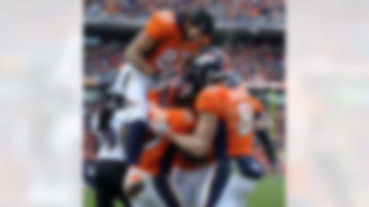 Denver Broncos wide receiver Eric Decker (87) leaps up to celebrate with tight end Joel Dreessen (81), wide receiver Demaryius Thomas (88) and running back Knowshon Moreno (27) after Moreno caught a pass for a touchdown against the Baltimore Ravens in the second quarter of an AFC divisional playoff NFL football game, Saturday, Jan. 12, 2013, in Denver. (AP Photo/Jack Dempsey)
