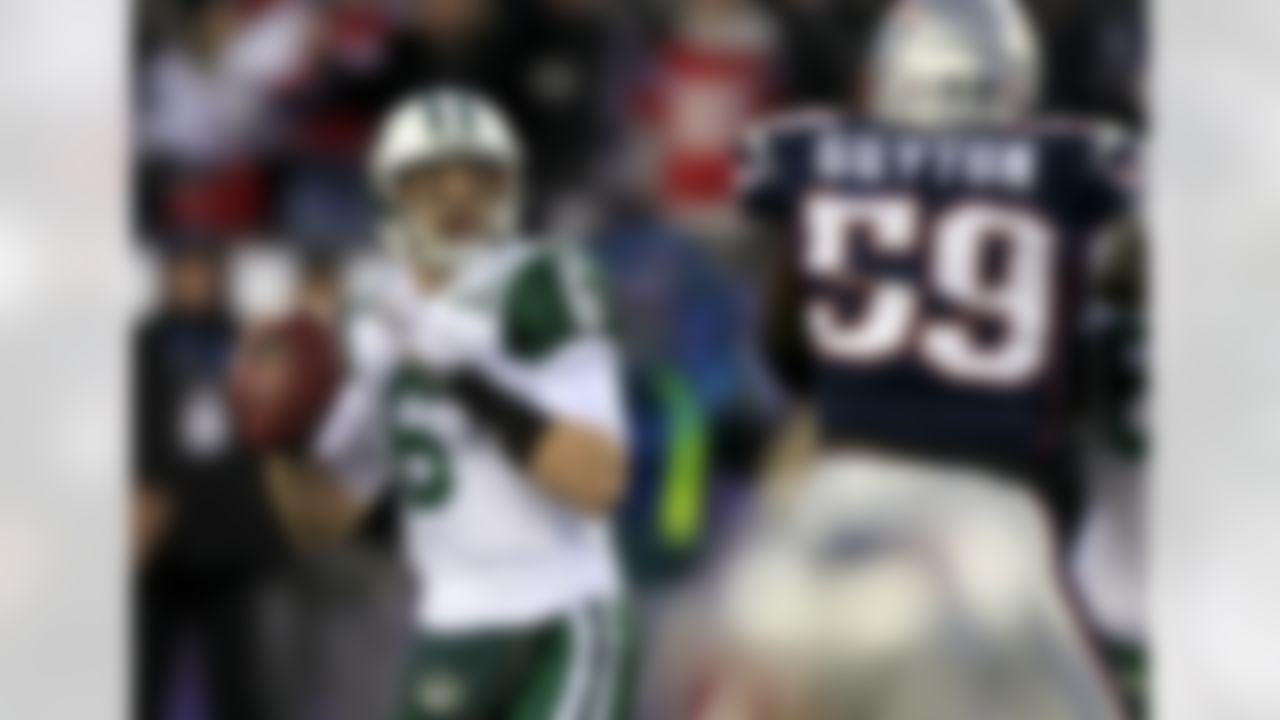 New York Jets quarterback Mark Sanchez (6) looks to pass as New England Patriots linebacker Gary Guyton (59) watches during the first quarter of an NFL divisional playoff football game in Foxborough, Mass., Sunday, Jan. 16, 2011. (AP Photo/Charles Krupa)