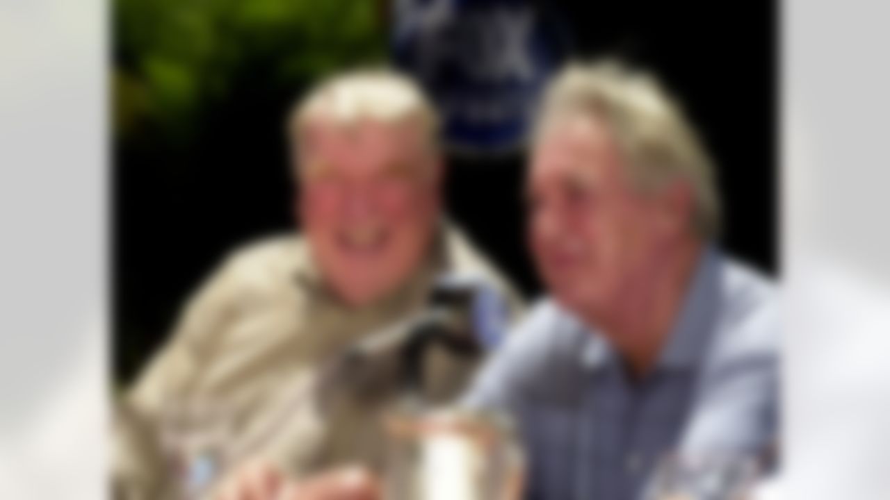 John Madden, left, NFL analyst on FOX Sports, smiles as Pat Summerall announces his retirement during a news conference Monday, July 24, 2000, in the Century City section of Los Angeles. The 2001-02 season will mark Summerall's 50th and final year with the NFL, as a player and a broadcaster. (AP Photo/Nick Ut)