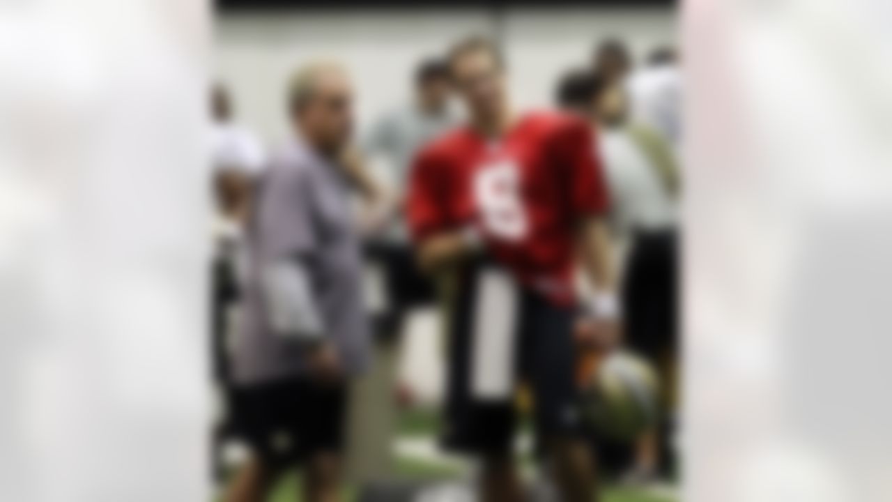 New Orleans Saints quarterback Drew Brees (9) talks with acting head coach Joe Vitt during the first practice of NFL football training camp at their indoor training facility in Metairie, La., Thursday, July 26, 2012. (AP Photo/Gerald Herbert)