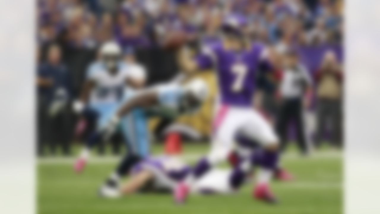 Minnesota Vikings quarterback Christian Ponder (7) looks to throw a pass in front of Tennessee Titans defensive tackle DaJohn Harris, left, during the first half of an NFL football game Sunday, Oct. 7, 2012, in Minneapolis. (AP Photo/Genevieve Ross)