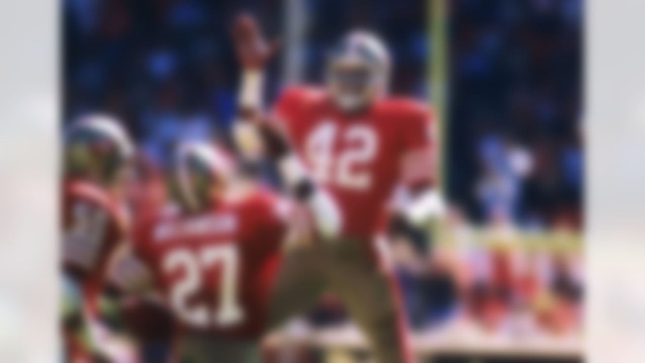 San Francisco 49ers defensive back Ronnie Lott (42) celebrates with defensive back Carlton Williamson (26) during an NFL game against the Chicago Bears on Sunday, Oct. 13, 1985, in San Francisco. The Bears won the game, 26-10. (AP Photo/Greg Trott)