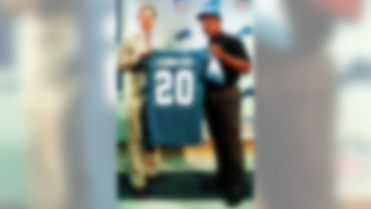 FILE--Detroit Lions first round draft pick Barry Sanders, right, holds his jersey with Lions vice president of finance Chuck Schmidt at the Pontiac Silverdome in Pontiac, Mich., in 1989. Sanders is quitting football, despite the near certainty of becoming the NFL's career rushing leader this season. "My desire to exit the game is greater than my desire to remain in it. I have searched my heart through and through and feel comfortable with this decision," Sanders said in a statement released Wednesday, July 28, 1999. (AP Photo/John Stormzand, File)