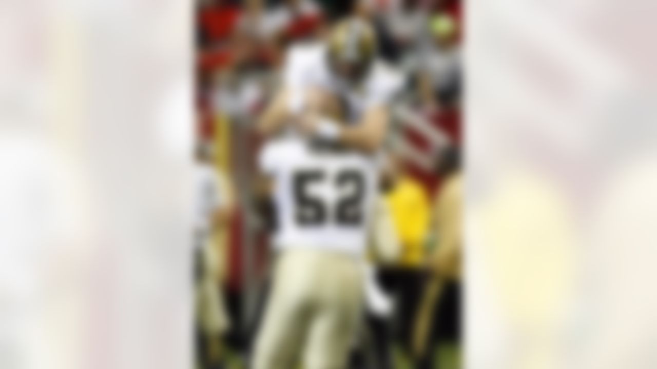 New Orleans quarterback Drew Brees (9) celebrates with center Jeff Faine (52) after tossing a touchdown on the Saints opening drive against Atlanta during the first half Sunday, November 26, 2006, at the Georgia Dome in Atlanta, Georgia. Photo by Getty Images.