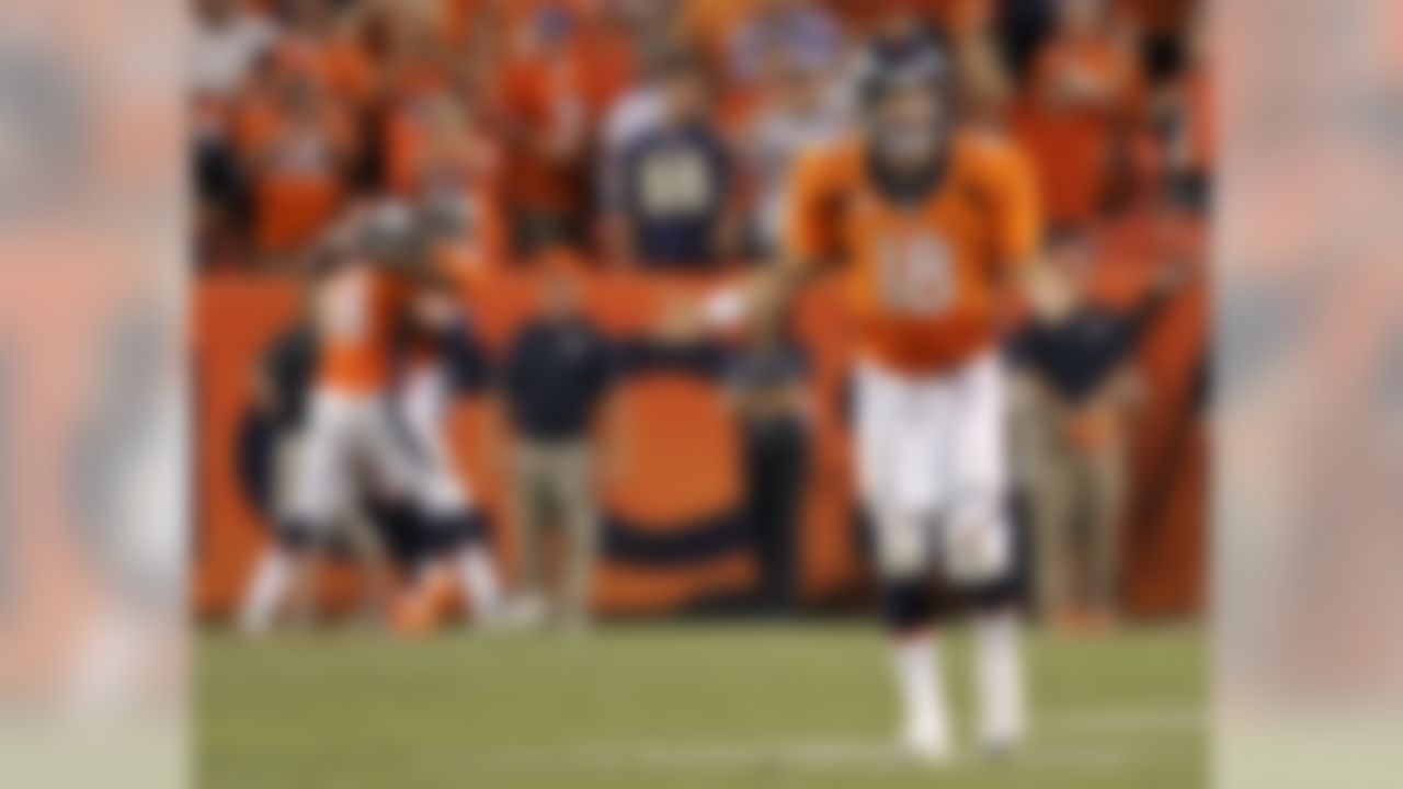 Denver Broncos quarterback Peyton Manning (18) celebrates his seventh touchdown of the game against the Baltimore Ravens during the second half of an NFL football game, Thursday, Sept. 5, 2013, in Denver. (AP Photo/Jack Dempsey)
