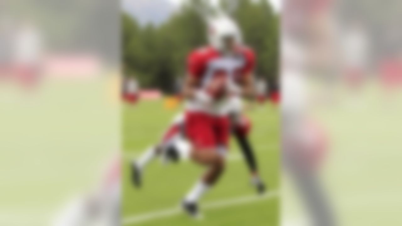 Arizona Cardinals' Gino Crump, front, makes a catch as Larry Parker (41) defends during NFL training camp football practice at Northern Arizona University Friday, July 27, 2012, in Flagstaff, Ariz.(AP Photo/Ross D. Franklin)