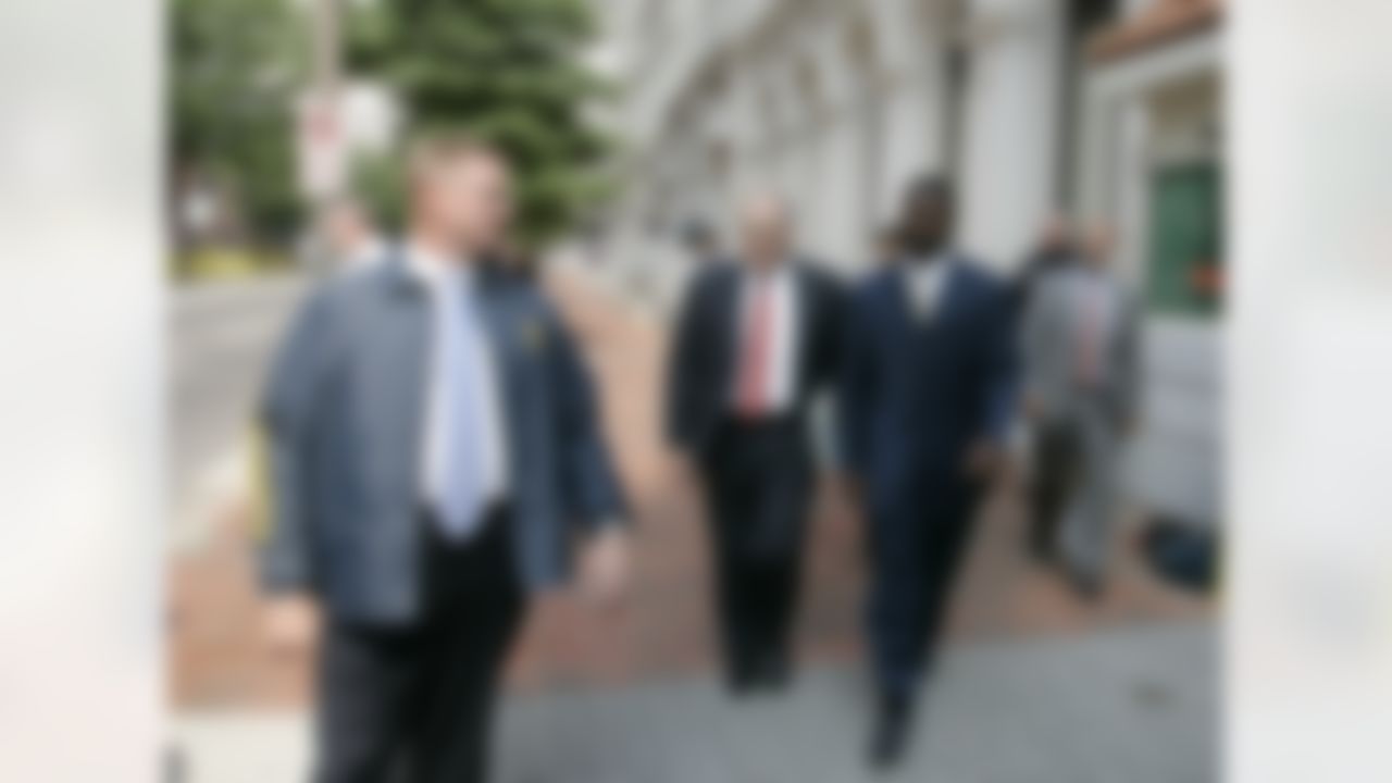 RICHMOND, VA - AUGUST 27: Atlanta Falcons quarterback Michael Vick (R) leaves federal court with attorney Lawrence Woodward (C) escorted by a federal marshal August 27, 2007 in Richmond, Viriginia. Vick pleaded guilty to a federal dogfighting charge. (Photo by Steve Helber-Pool/Getty Images)