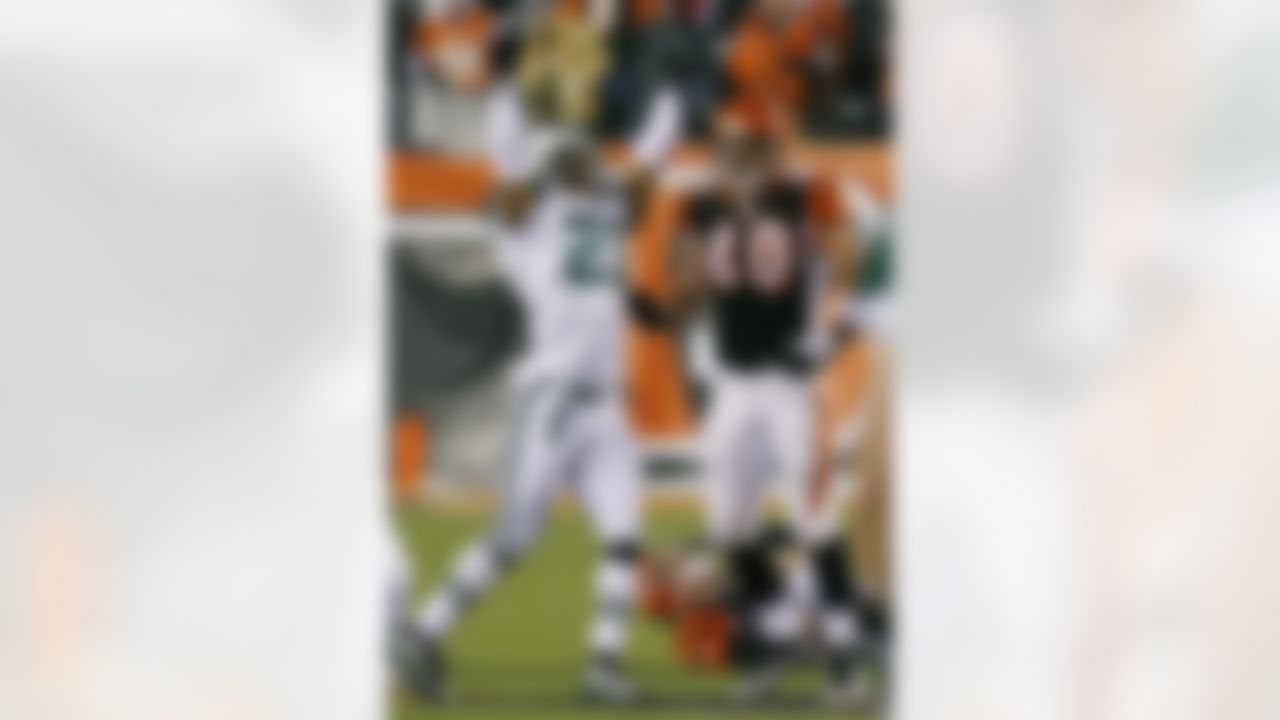 New York Jets cornerback Dwight Lowery (21) celebrates next to Cincinnati Bengals fullback Brian Leonard (40) after the Jets sacked Bengals quarterback Carson Palmer, right, on the ground, in the second half of an NFL wild-card playoff football game, Saturday, Jan. 9, 2010, in Cincinnati. New York won the game 24-14. (AP Photo/David Kohl)