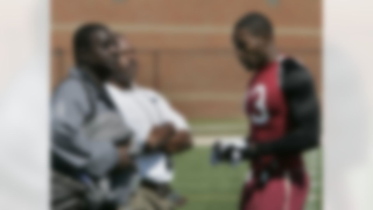 Antonio Cromartie, right talks with Seattle Seahawks defensive coordinator Ray Rhodes, left and Rod Perry, Carolina Panthers defensive back coach at Pro Day, Thursday March 16, 2006 in Tallahassee, Fla. (AP Photo/Steve Cannon)