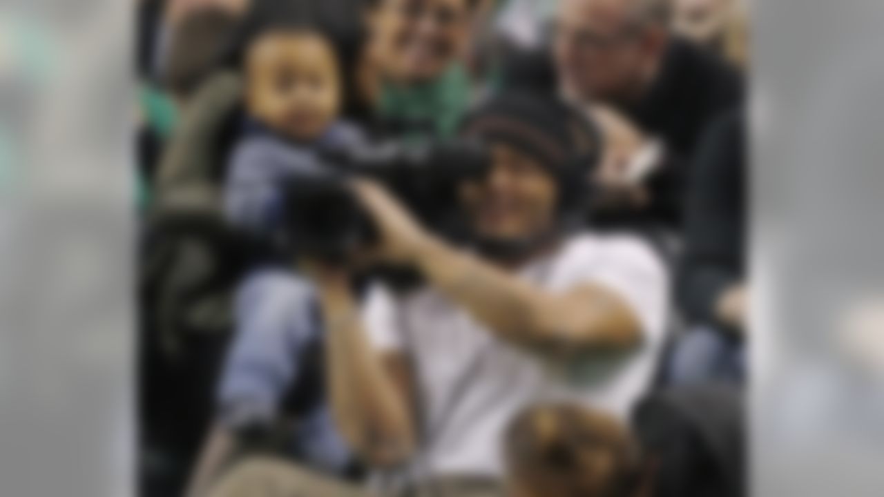 New England Patriots free safety Patrick Chung tries his hands as an on court cameraman during the first half of an NBA basketball game between the Boston Celtics and the Chicago Bulls in Boston on Friday, Jan. 18, 2013. (AP Photo/Charles Krupa)